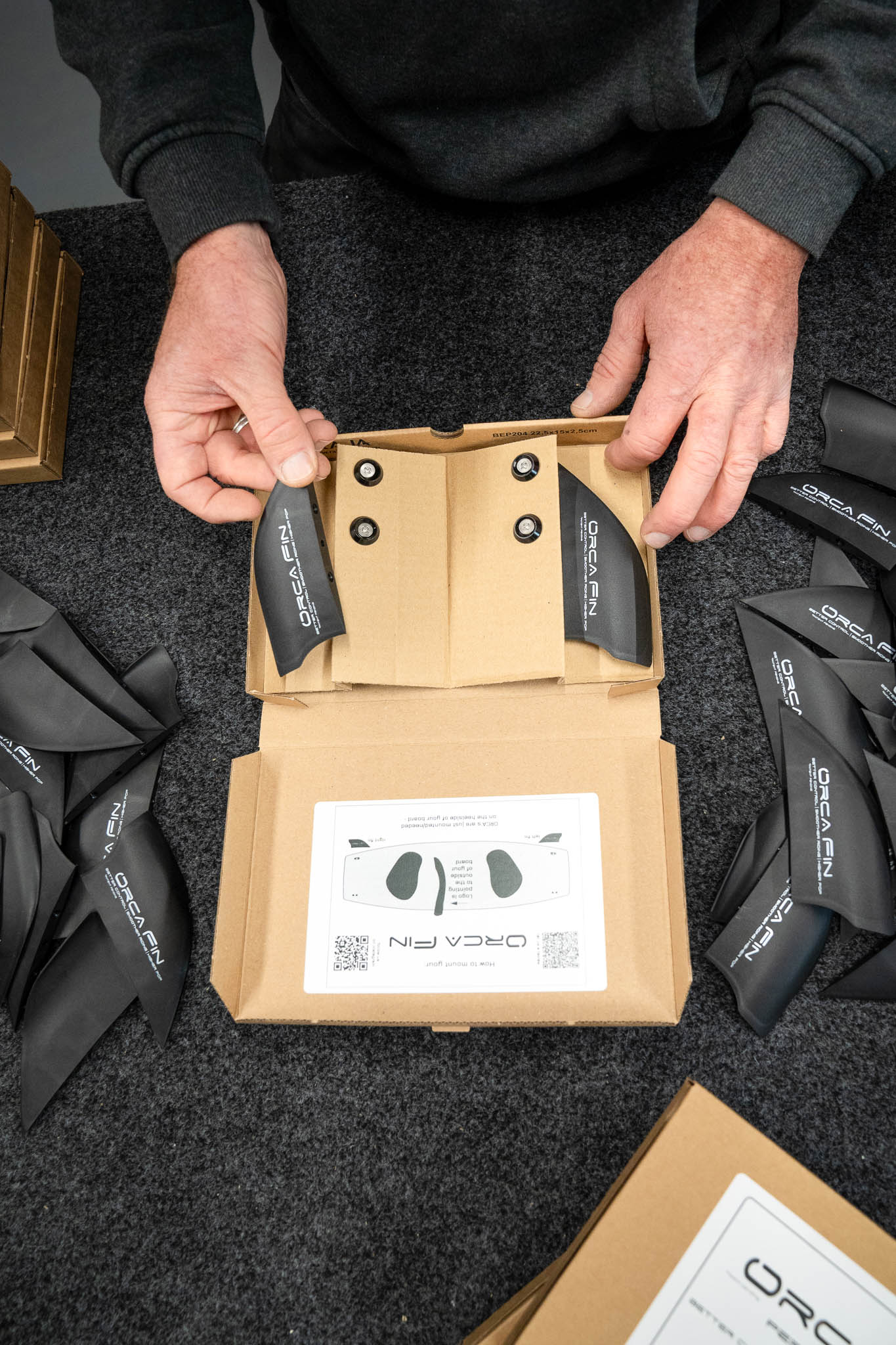 Orca Fins unboxing kit with kiteboard fins, M5 screws and aluminum washers