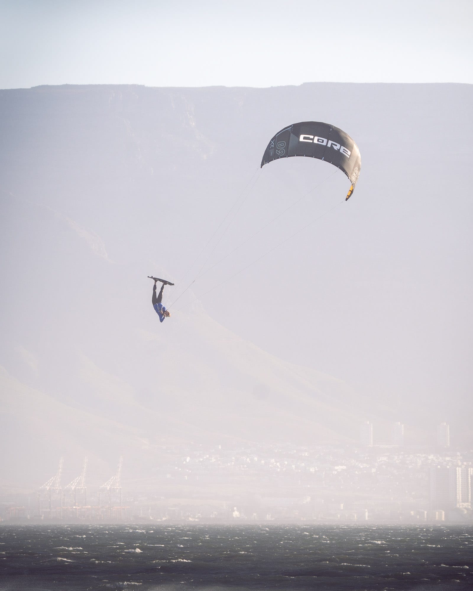 kitesurfer sending a big-air jump on twin-tip with Orca Fins for kiteboarding