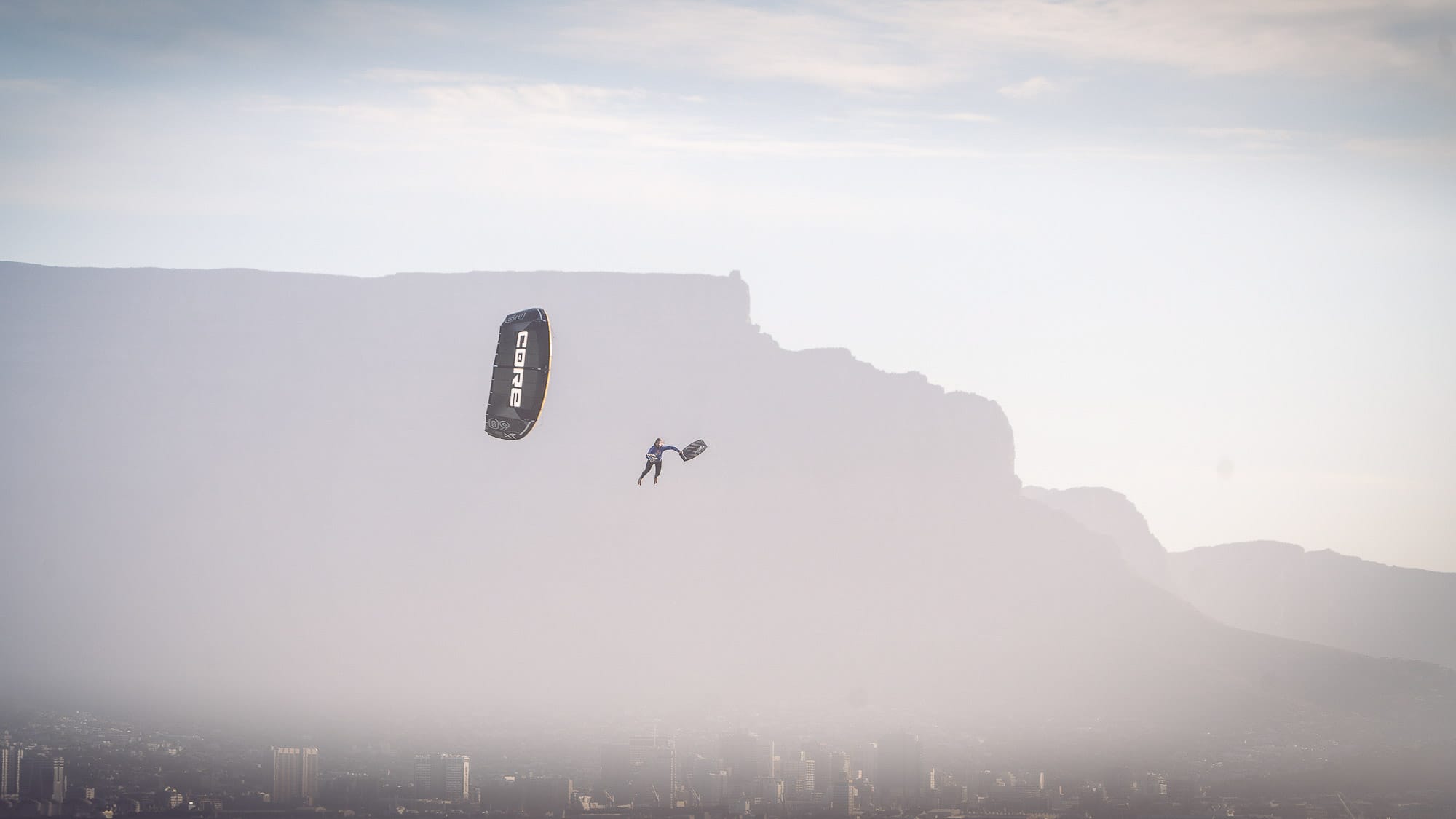 kitesurfer big-air jump using Orca Fins on a twin-tip